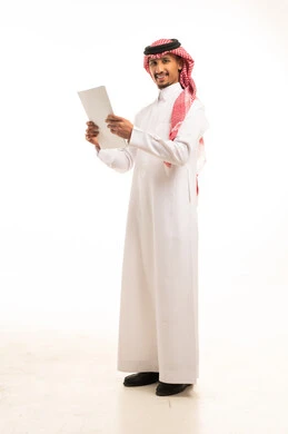 رجل أعمال سعودي بالثوب التقليدي يمسك ملف ورقي رسمي