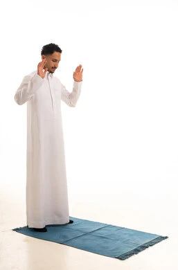 Saudi Man Praying in White Thobe on White Background