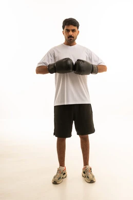 Saudi Athlete in Boxing Gloves on White Background