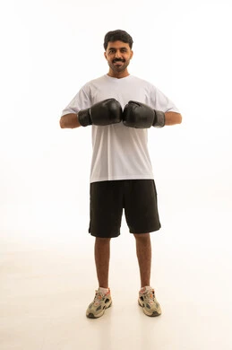 Saudi Man Wearing Boxing Gloves in Sportswear Studio Shot