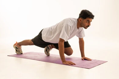 Arabic Man Performing Exercise on Yoga Mat in Studio