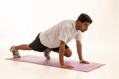 Arab Man Performing Mountain Climber Exercise in Studio