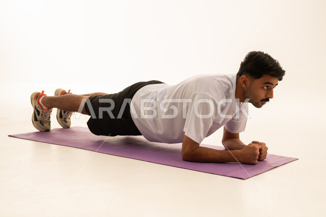 Saudi Man Performing Plank Exercise in Studio