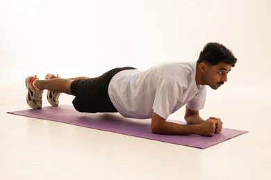 Saudi Man Performing Plank Exercise in Studio