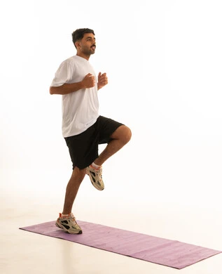 Arab Man Wearing Sportswear Exercising in Studio