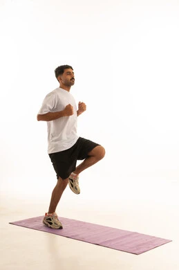 Arab Man Exercising on Yoga Mat in Studio
