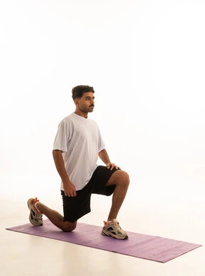 Arab Man Doing Lunges on Yoga Mat White Background