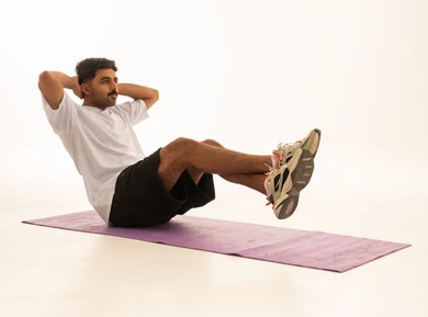 Saudi Man Performing Abdominal Core Exercise in Studio