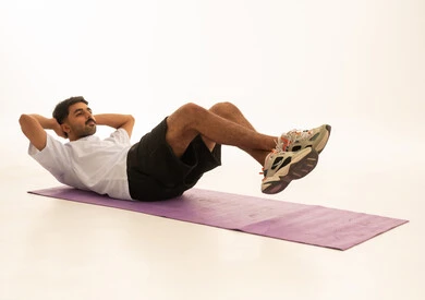 Saudi Man Performing Abdominal Exercise on Yoga Mat