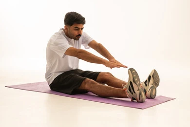 Saudi Man Stretching on Yoga Mat White Background