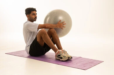 Saudi Man Training with Fitness Ball in Studio