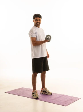 Indian Man Exercising With Dumbbell on White Background