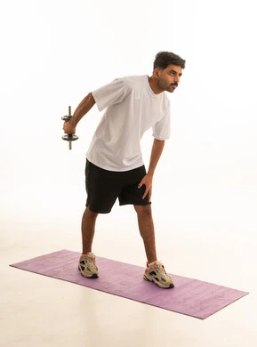 Saudi Man Exercising with Dumbbell in Studio