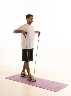 Arab Man Using Resistance Bands in White Fitness Studio