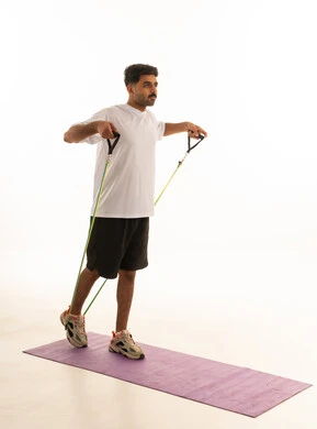 Arab Man Resistance Band Fitness Workout in Studio