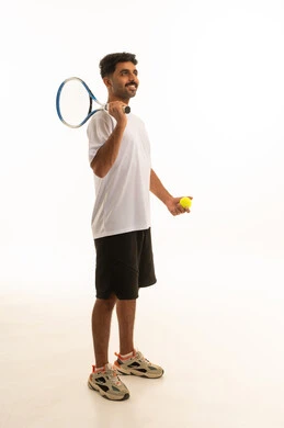 Saudi Athlete Holding Tennis Racket in Studio Saudi Athlete Holding Tennis Racket in Studio