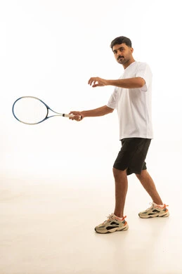 Saudi Man Playing Tennis in White Studio