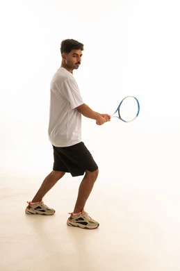 Arab Man Playing Tennis in Studio on White Background