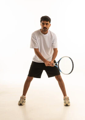 Saudi Man Holding Tennis Racket in Studio Saudi Man Holding Tennis Racket in Studio