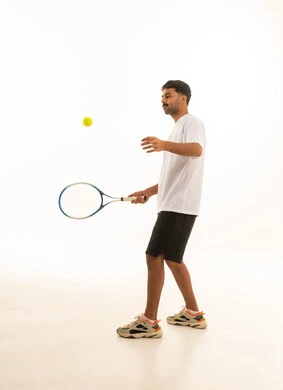Saudi Athlete Holding Tennis Racket in Studio