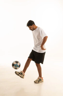 Arab Man Juggling Football on White Background