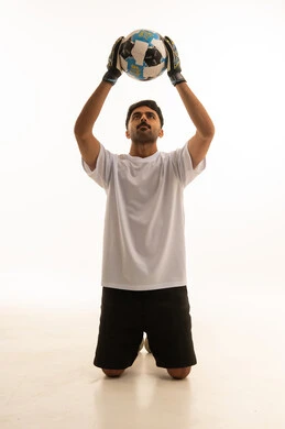 Saudi Soccer Goalkeeper Holding Football in Studio