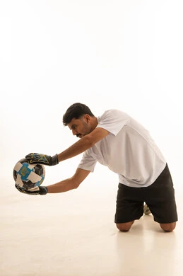 Saudi Male Goalkeeper Holding Football in White Studio