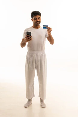 Saudi Man Using Credit Card and Smartphone Studio Shot