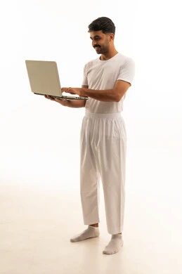 Saudi Man in White Undergarments Using Laptop