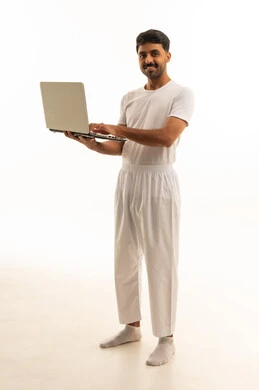 Saudi Man with Laptop in Traditional White Clothing