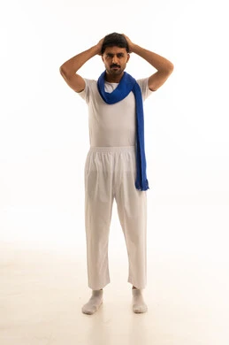 South Asian Man in White Clothing Expressing Stress