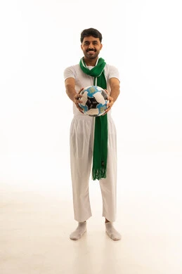 Saudi Man with Green Scarf Holding Football in Studio