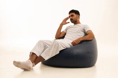 Saudi Man in White Undergarments on Bean Bag