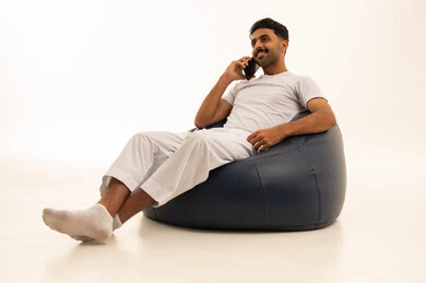 Saudi Man in Traditional Undershirt Using Smartphone