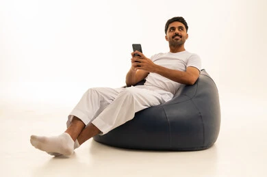 Saudi Man Using Smartphone on Bean Bag Studio