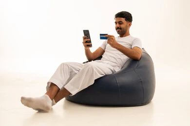 Saudi Man Using Credit Card on Bean Bag Studio