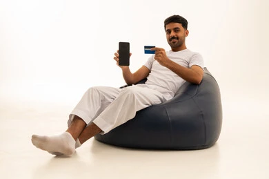 Saudi Man with Smartphone and Credit Card on White