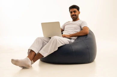 Saudi Man with Laptop on Bean Bag White Background