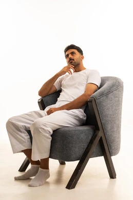 Saudi Man Sitting on Modern Armchair Thinking