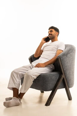 رجل سعودي يتحدث بالهاتف جالساً على كرسي