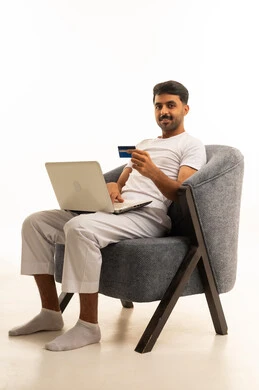 Saudi Man Online Shopping with Laptop and Credit Card