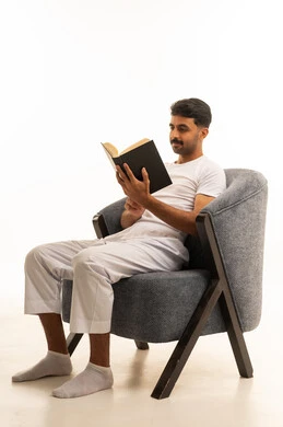 Saudi Man Reading Book in Grey Armchair Studio