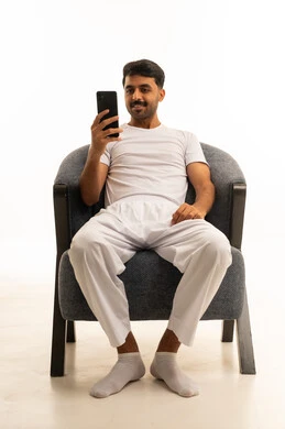 Saudi Man in Traditional White Innerwear Using Smartphone