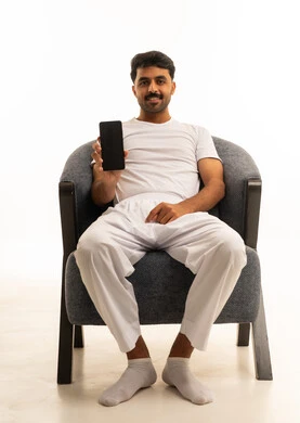 Saudi Man in White Clothing Holding Smartphone