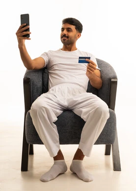 Saudi Man with Credit Card and Smartphone in White Studio