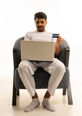 Saudi Man Using Laptop and Credit Card on White Background