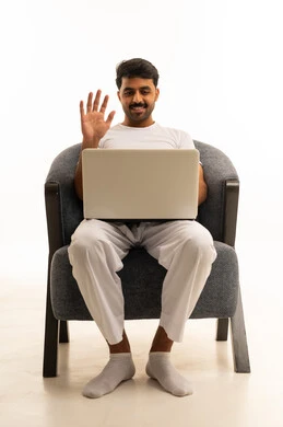 Saudi Man Using Laptop and Waving on White Background