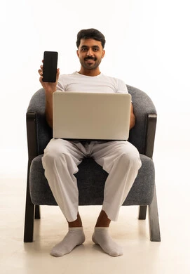 رجل سعودي مع لابتوب وهاتف ذكي خلفية بيضاء