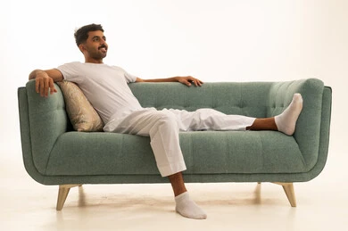 Saudi Man in White Loungewear on Modern Sofa