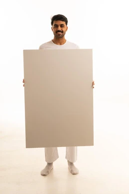 Indian Man Holding Large Blank White Board in Studio